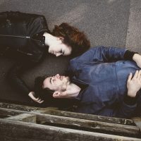 adulttale 剧情研究员秋迟对着多屏比对互动叙事作品不同分支走向的画面，屏幕冷光映在脸上，深夜梳理脉络的安静场景